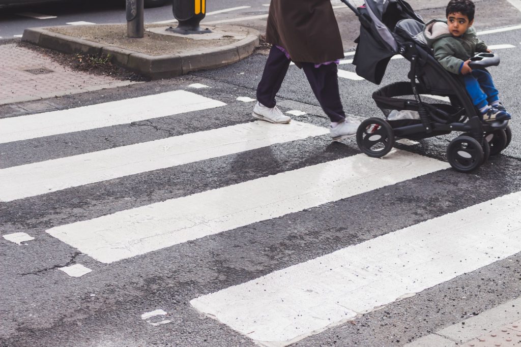 Stroller Being Pushed on Crosswalk